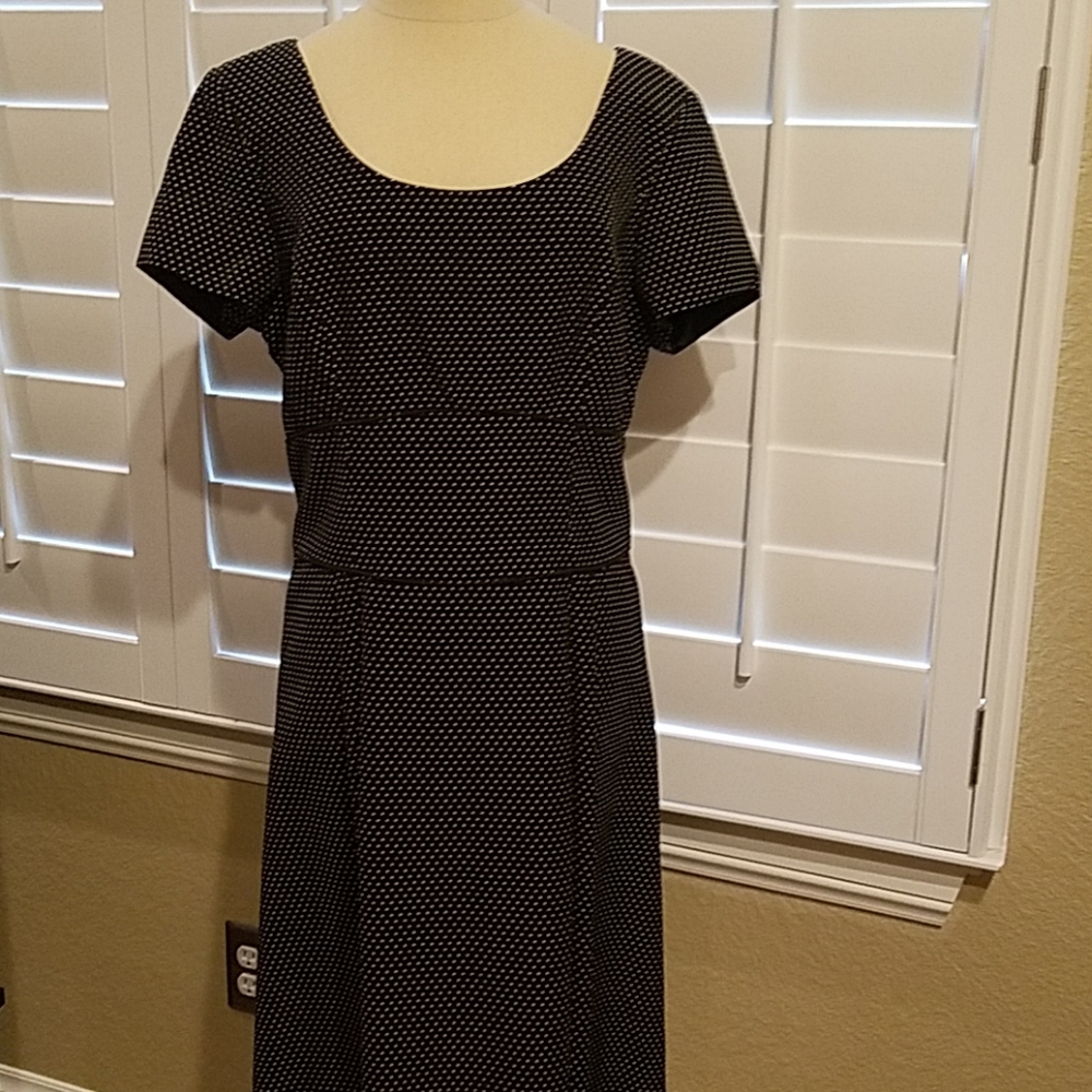 Black dress with white polka dot print.